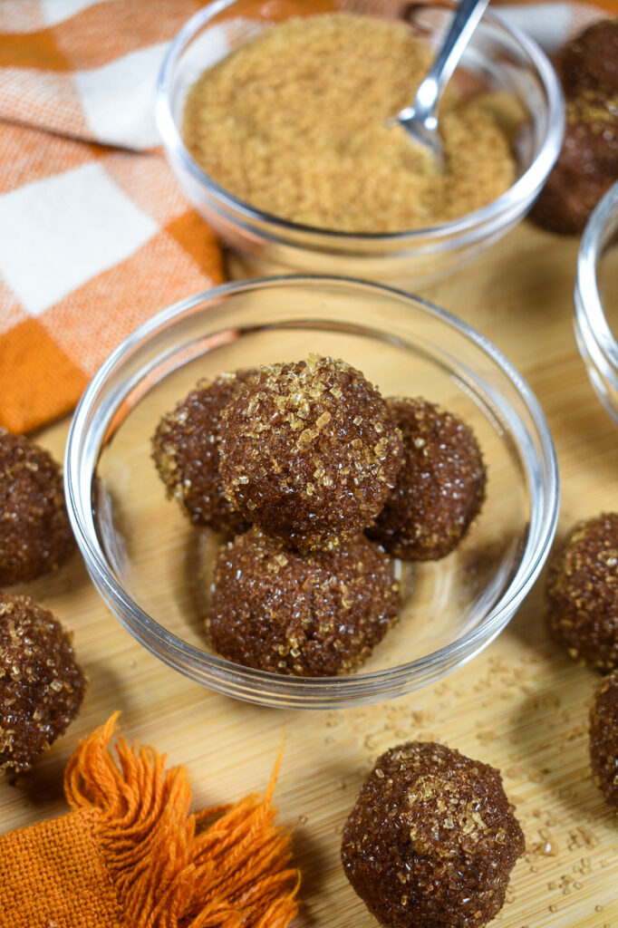 a bowl of pumpkin spice truffles with crunchy sugar coating