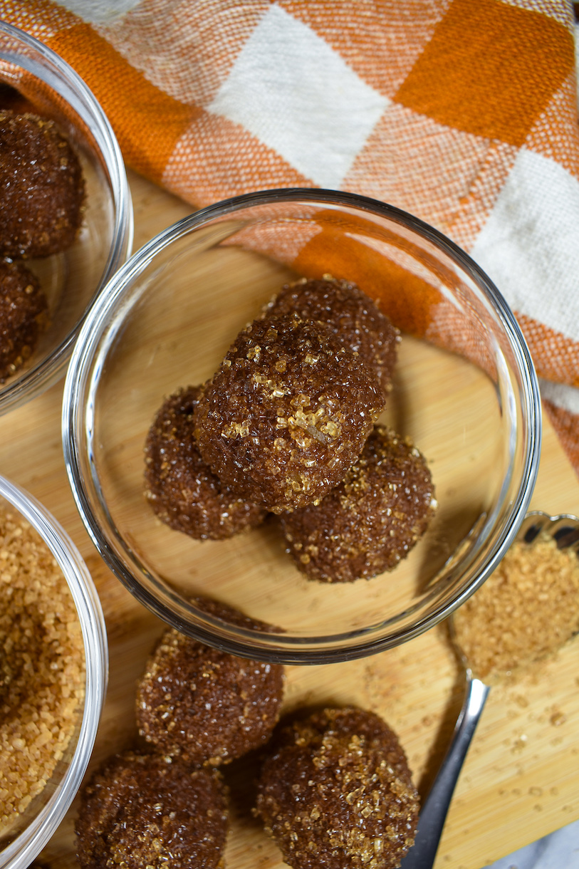a bowl of pumpkin spice truffles and an orange checkered tea towel