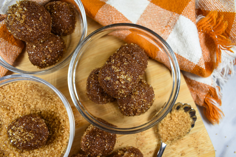 a dish of milk chocolate pumpkin spice truffles and an orange checkered tea towel