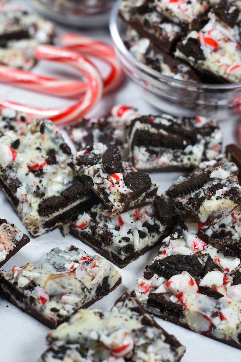 peppermint bark on a white surface with candy canes