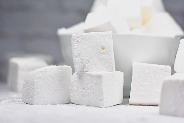a stack of vanilla bean marshmallows on a white surface