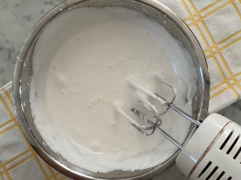 bowl of marshmallow fluff with hand mixer