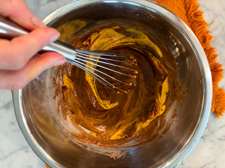 whisking pumpkin with melted chocolate