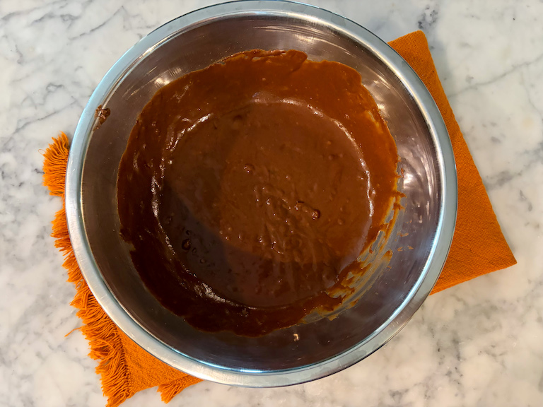 milk chocolate pumpkin ganache in a metal bowl