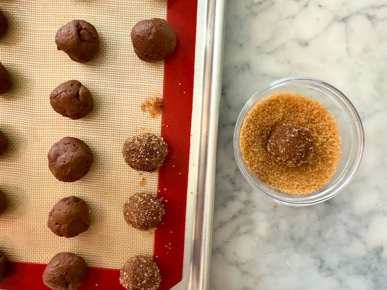 rolling pumpkin spice truffles in demerara sugar