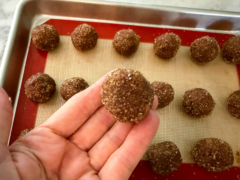 hand holding a chocolate truffle rolled in demerara sugar