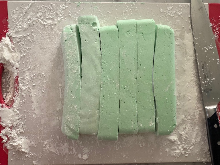 cutting peppermint marshmallows with a sharp knife