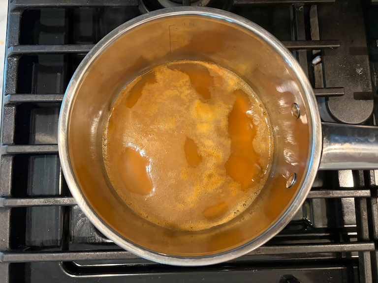 cider reducing in a pan on the stovetop