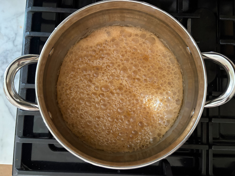 caramel and cream bubbling in a pot