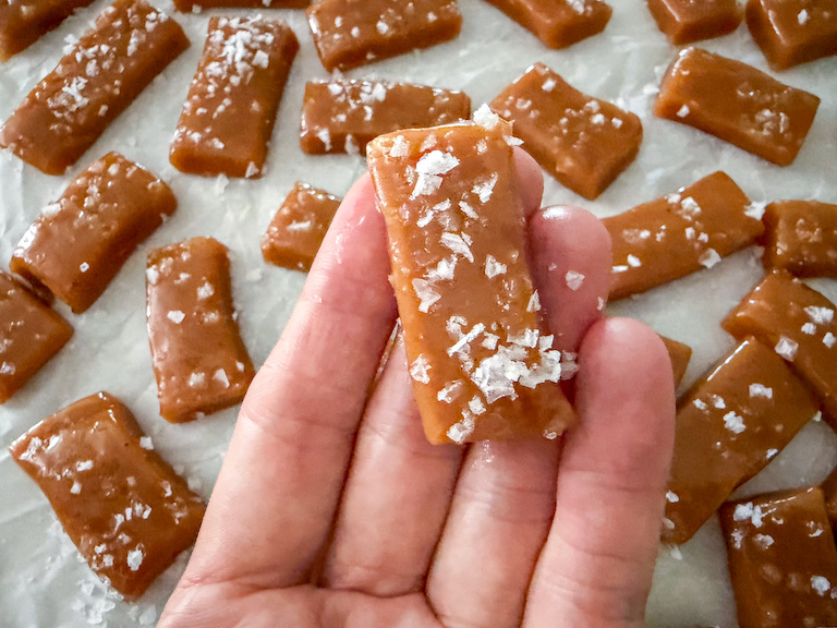 hand holding a salted apple cider caramel