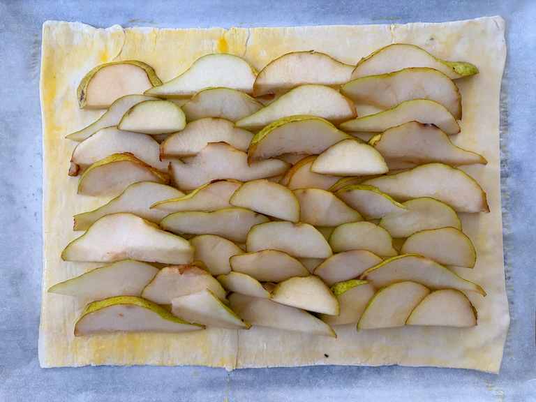 pears layered on a sheet of puff pastry