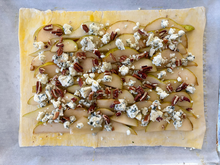 pears, blue cheese, and nuts scattered on puff pastry