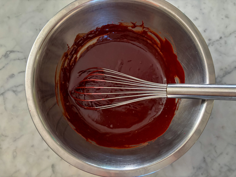 ganache in a bowl with a whisk