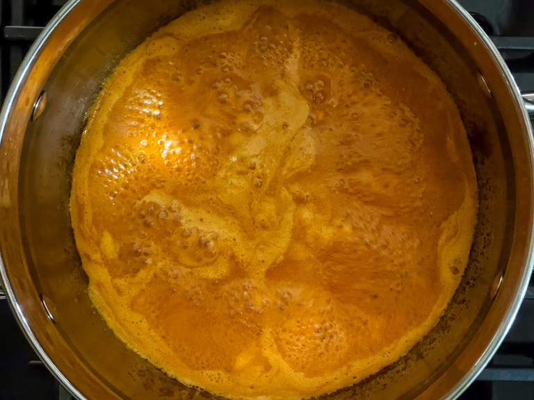 carrot candy syrup boiling in a pan