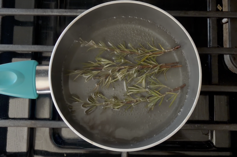 sugar, water, and rosemary sprigs in a pan