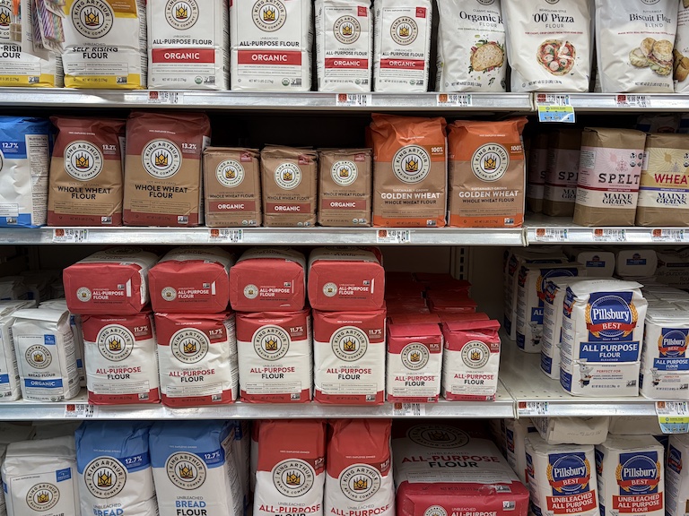 bags of flour on the shelf at a supermarket