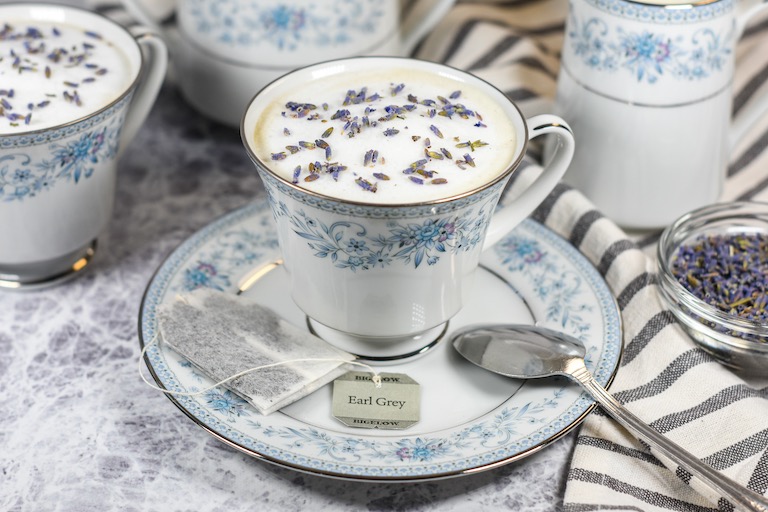 lavender London fog in a ceramic teacup, arranged on a ceramic saucer