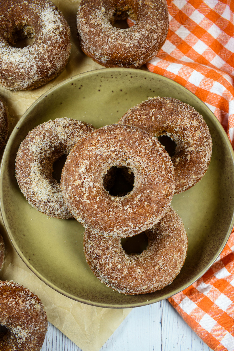 a stack of apple cider doughnuts on a plate