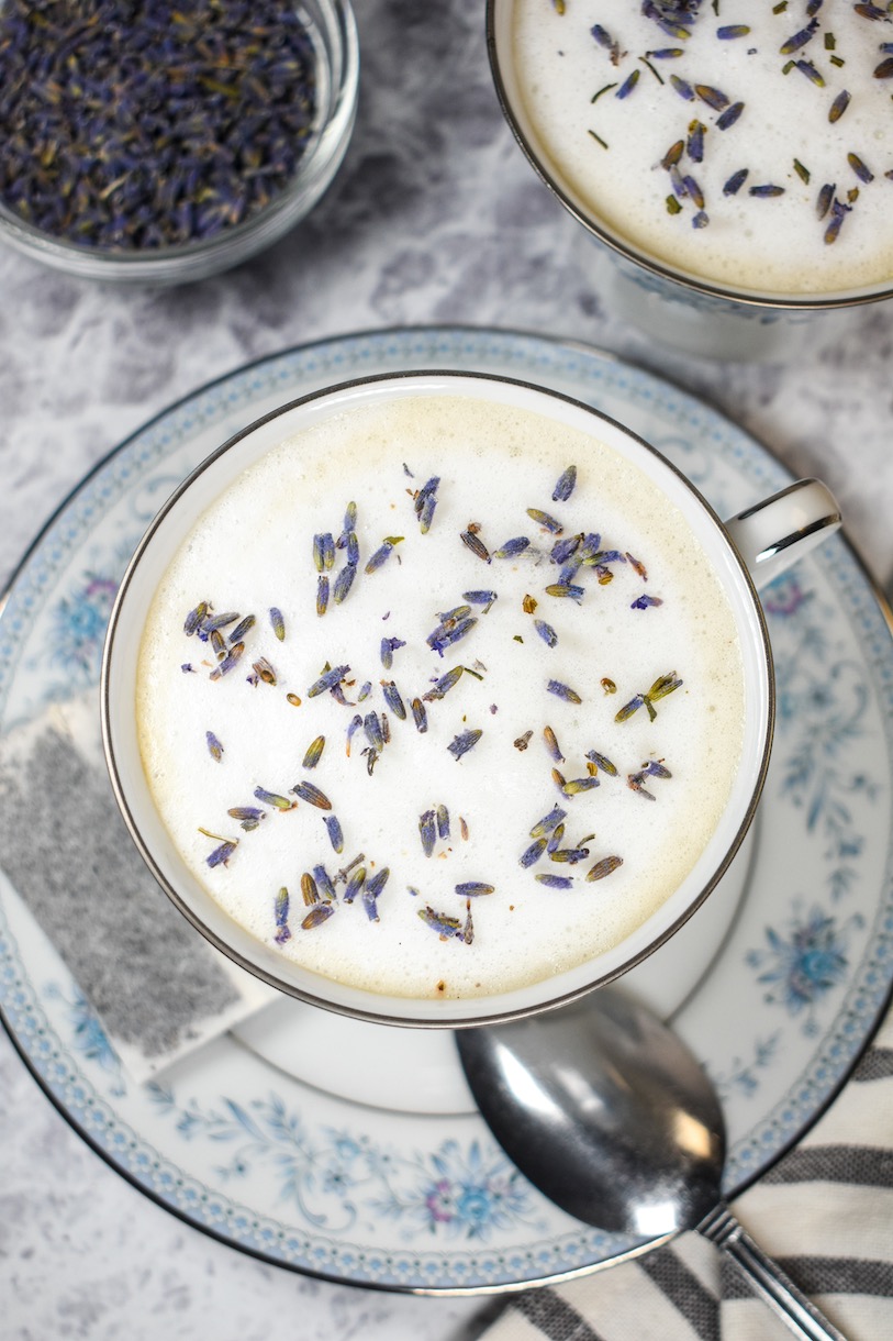 looking down at a lavender london fog in a ceramic teacup with lavender buds on top