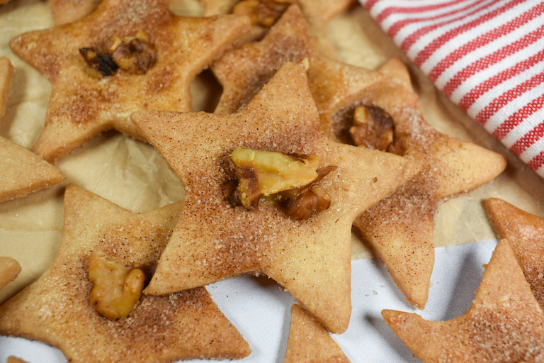 star shaped sand tarts decorated with cinnamon sugar and walnuts
