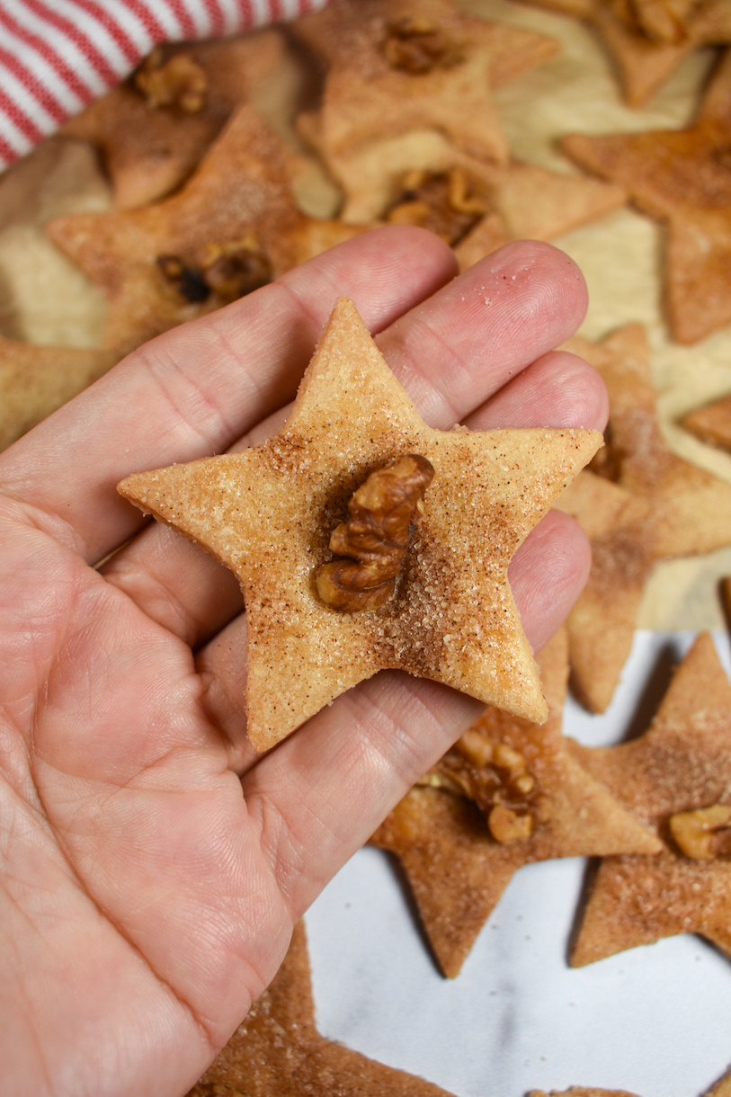 hand holding a star shaped PA Dutch sand tart Christmas cookie