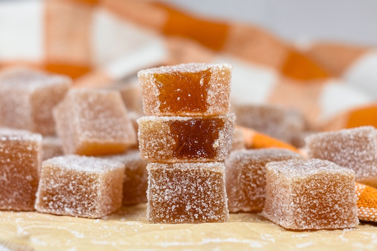 a stack of apple cider gummies and an orange plaid towel