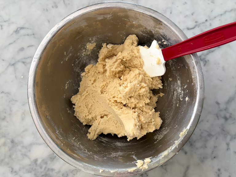 a bowl of sand tart cookie dough with a spatula