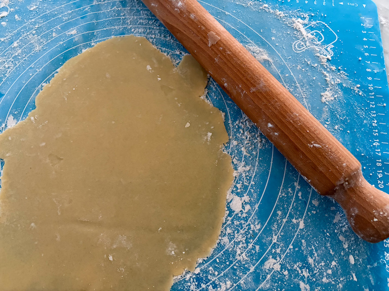rolling sand tart dough with a rolling pin