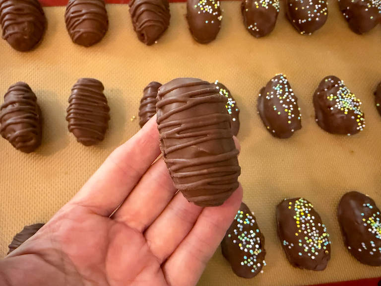 hand holding a buttercream easter egg