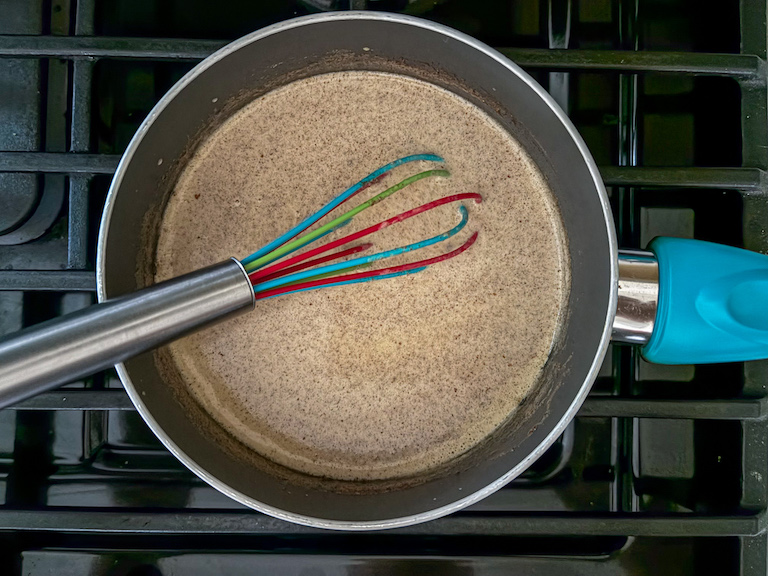 warming cream and spices in a pan on the stovetop