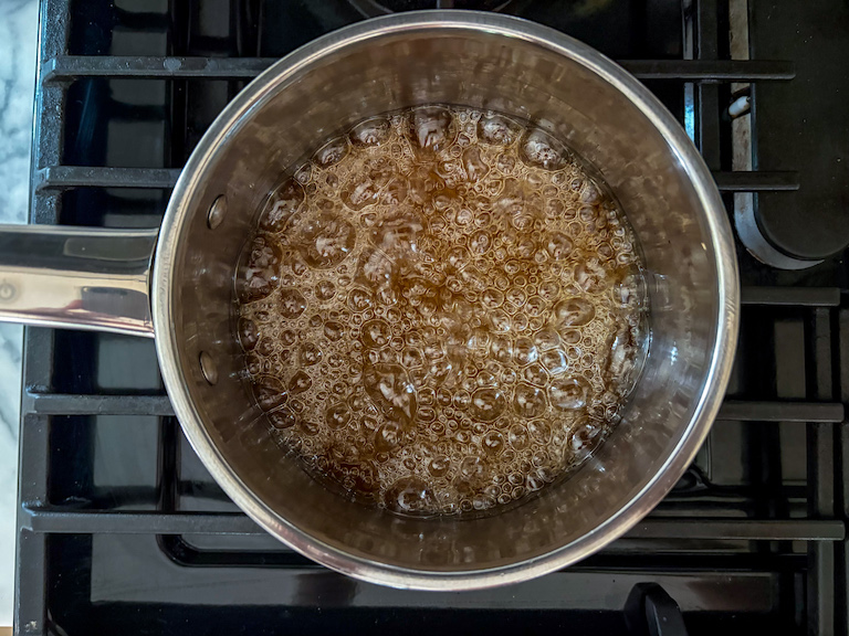 caramel bubbling in a pan on the stovetop
