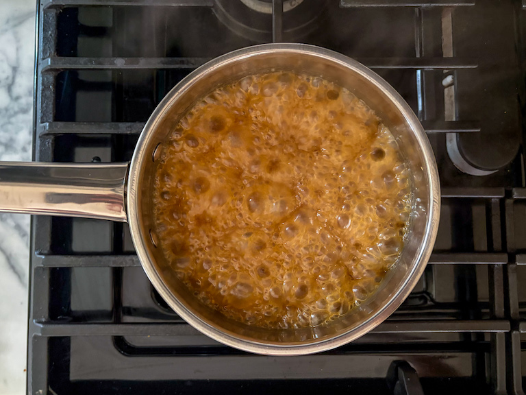 caramel bubbling in a pan on the stovetop