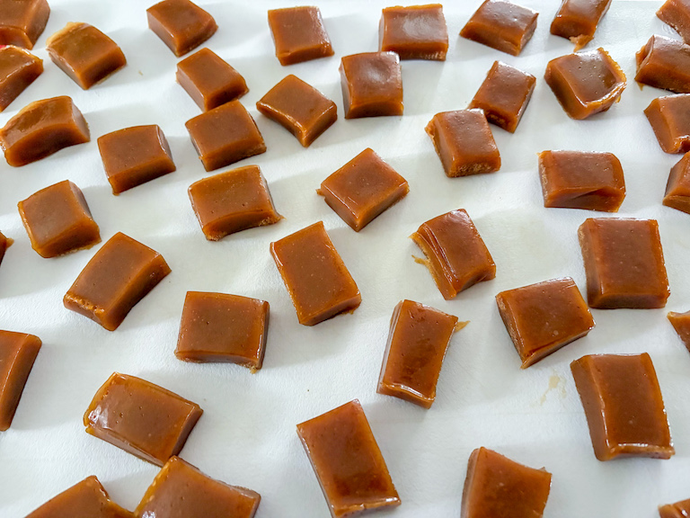 pumpkin caramels arranged on a cutting board