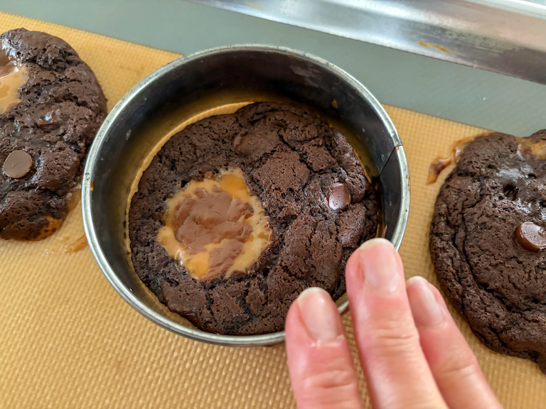 reshaping milk dud cookies with a round cookie cutter