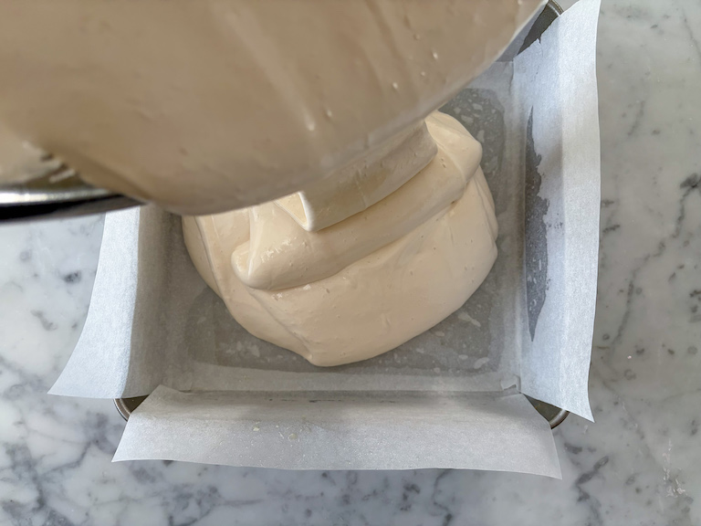 pouring marshmallow fluff into a tin