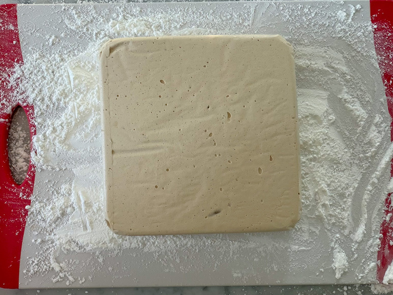 coffee marshmallow slab on a dusted cutting board