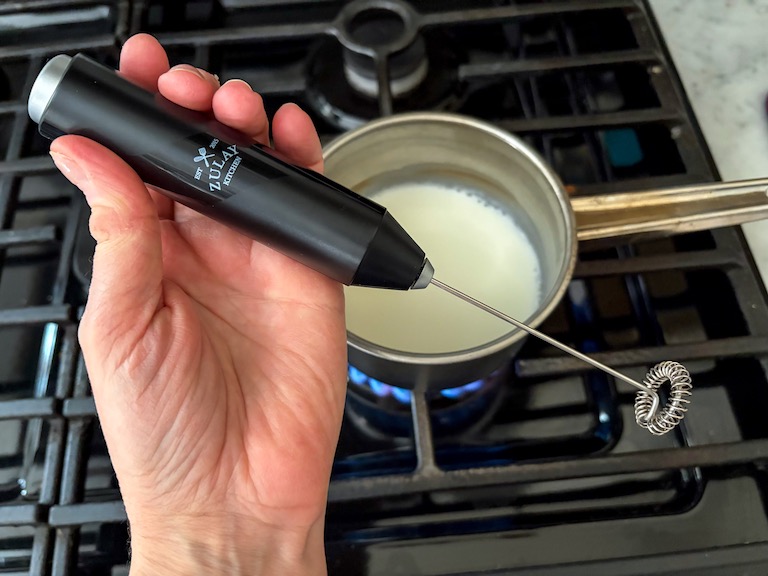frothing milk with a milk frother