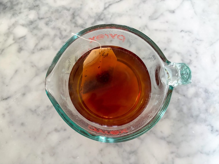 tea steeping in a measuring cup