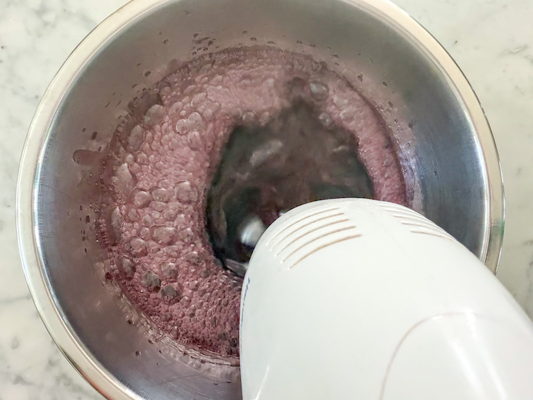 mixer mixing red wine in a bowl