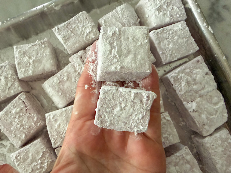 hand holding two homemade marshmallows