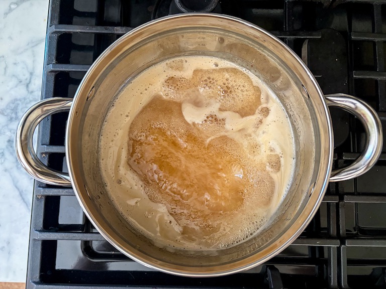 apple cider syrup in a pot on the stovetop