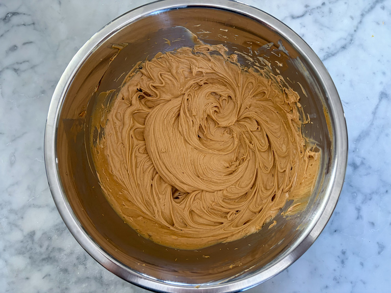 peanut butter and butter whipped in a metal bowl