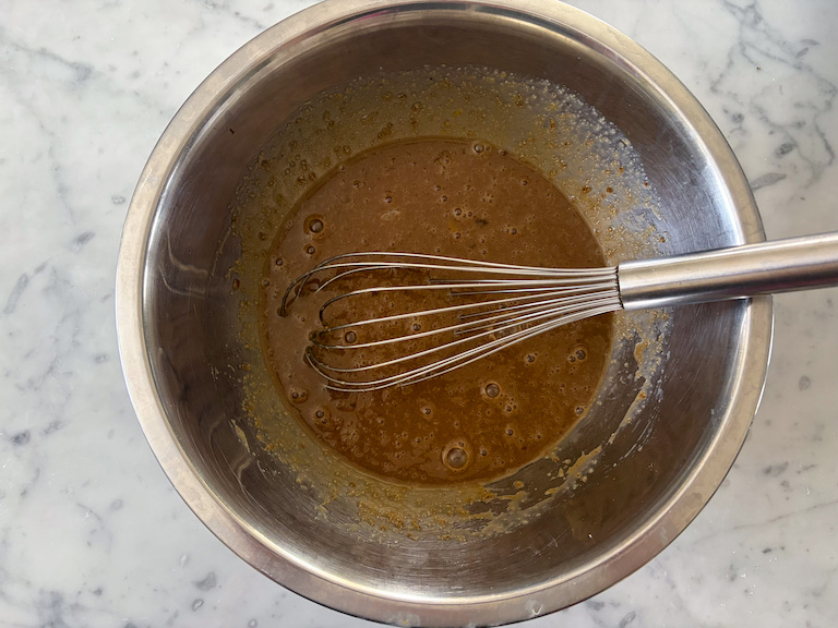 wet ingredients in a bowl with a whisk