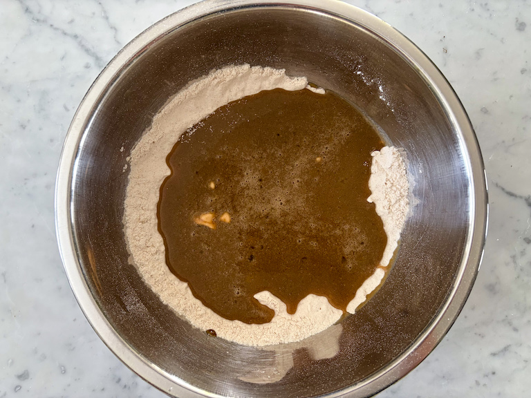 mixing wet and dry ingredients in a metal bowl