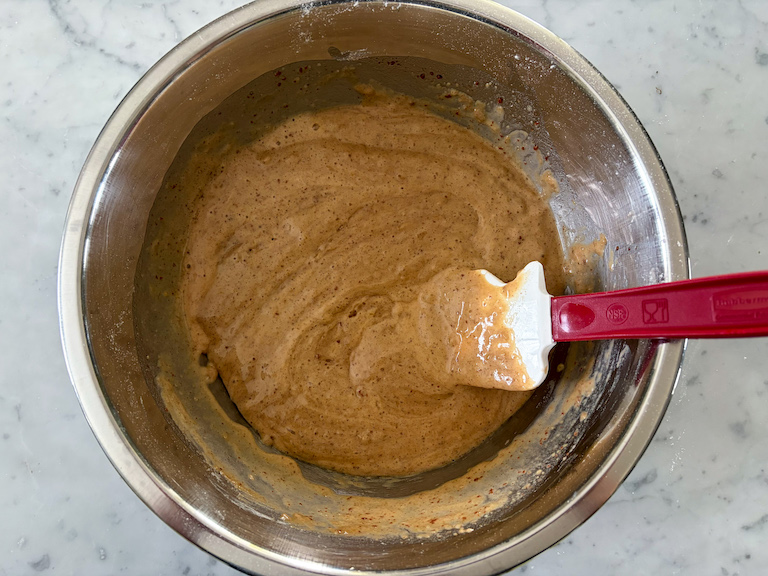 cider donut batter in a bowl with a spatula