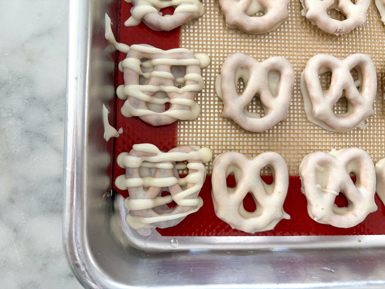 white chocolate pretzels piped with zigzags of white chocolate