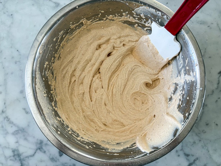 pumpkin pie whipped cream in a bowl with a spatula
