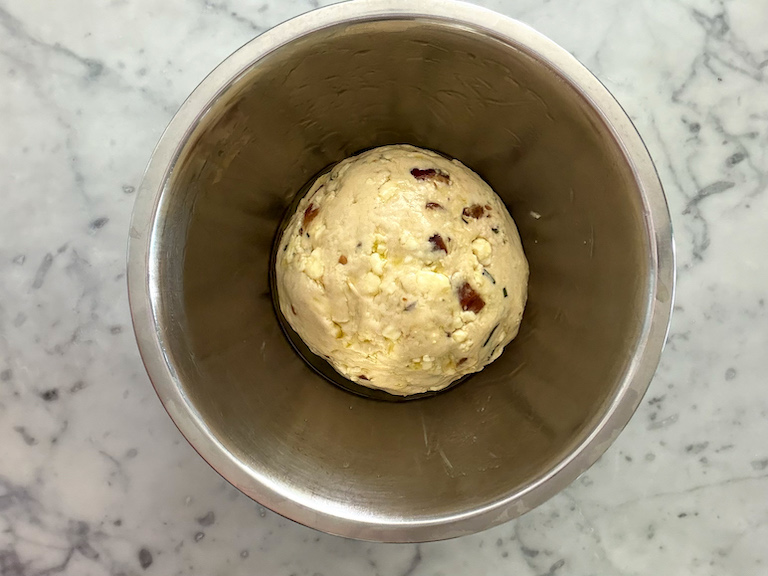 ball of bread dough in an oiled mixing bowl