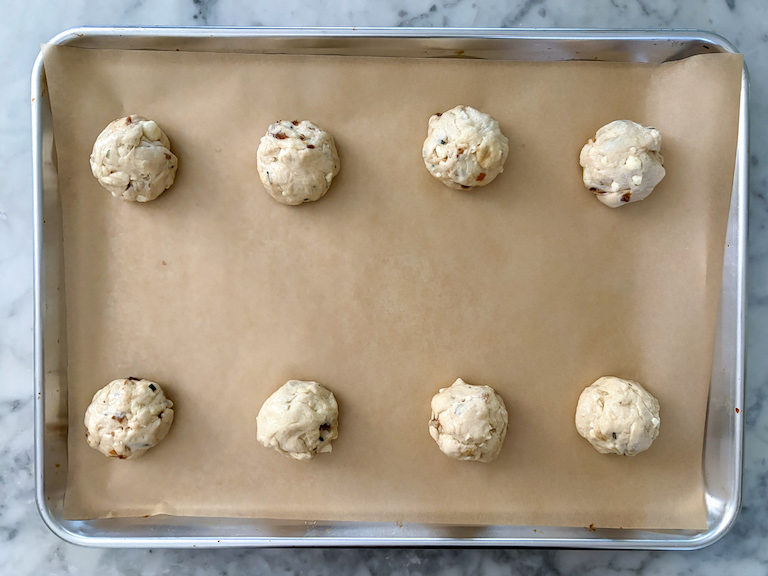 dinner rolls arranged on a parchment lined tray