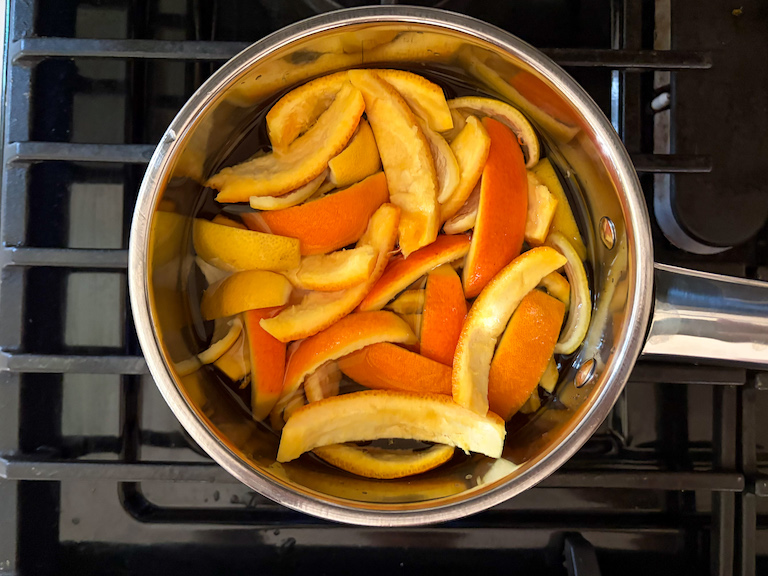 orange peels and water in a pan